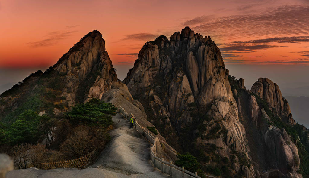 It was impossible for my senses to ignore the wonder of the Huangshan mountains as if they were posing for my lens and allowing me to capture their splendor. That sunset showed me a beautiful orange light and let me see many viewpoints, endless stairs, bridges to cross from one mountain to another. This image was taken in November 2019, at Huangshan Mountain, China.  Title: "Dreamy Mountains" Note: Panoramic of 4 photos, edited in LR and dPS